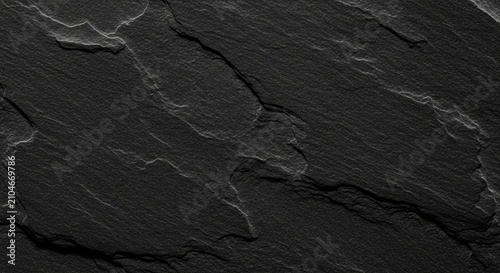 Dark black slate stone texture background. Natural rock surface with rough uneven pattern. Abstract architectural material for interior design backdrop and construction concept.