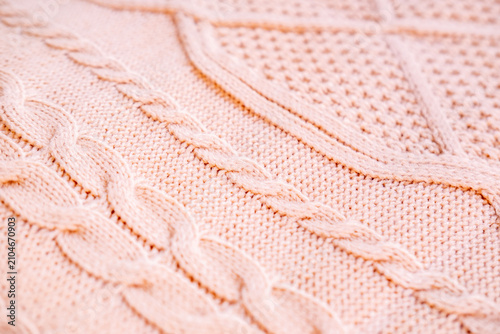 hand knitted wool texture braided cables and twisted patterns, Soft cable-knit texture, warm wool fabric, cozy winter wear, artisanal craftsmanship, traditional heritage and skill, fashion background