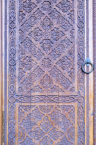 Intricate Hand-Carved Wooden Door with Islamic Floral Patterns