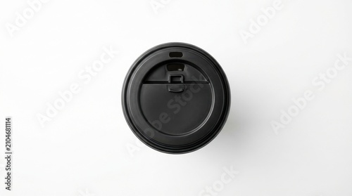 Top-down view of a black coffee cup lid on a white surface, isolated.