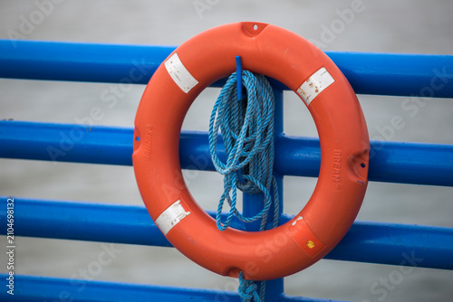 Life Buoy on Blue Railing by the Sea High quality commercial imagery suitable for marketing, advertising, editorial use, and professional stock catalo