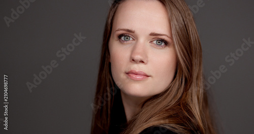 Obraz na plátně Woman with long brown hair posing for an expressive portrait