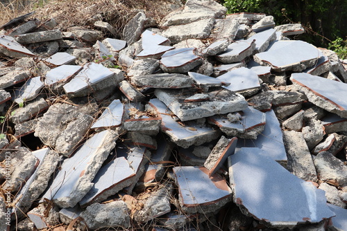 Large heap of shattered concrete pieces collected after building demolition for material recycling