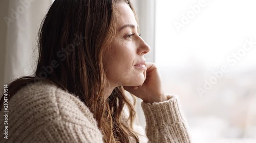 Woman looking out the window sadness.