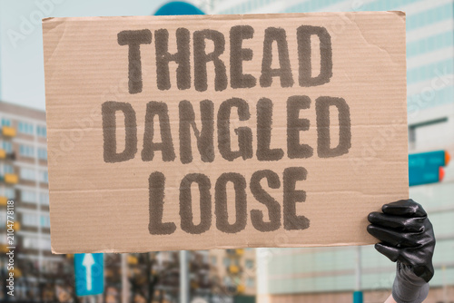 Fotografie "Thread Dangled Loose" Fibers hung down from the sleeve