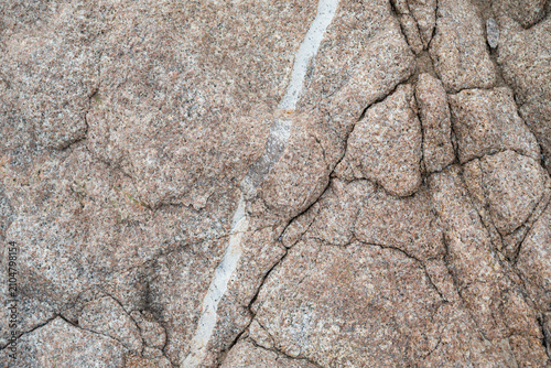 Weathered granite texture with natural white mineral vein background