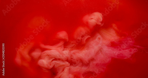 Cloud dye. Paint fog. Red orange pigment spray burst in bright watercolor liquid. Vibrant haze color blend abstract blur background.