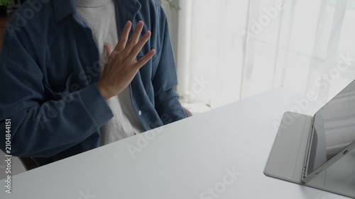 Asian man learning to using sign language