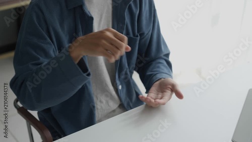 Asian man learning to using sign language