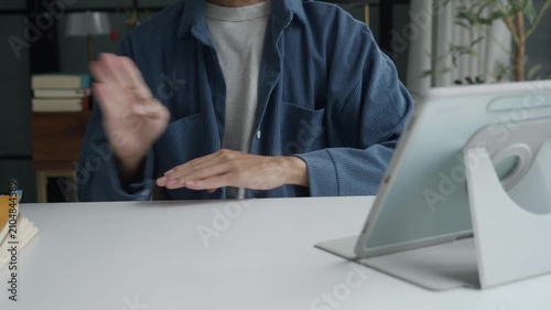 Asian man learning to using sign language