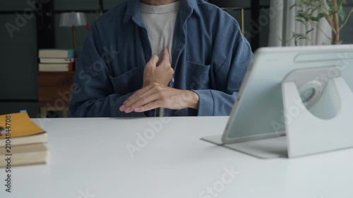 Asian man learning to using sign language