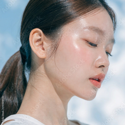 Beautiful young woman with healthy skin on color background