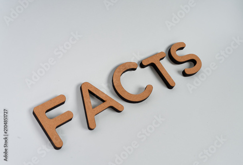 Foto Separate letters spelling FACTS arranged diagonally isolated on white background