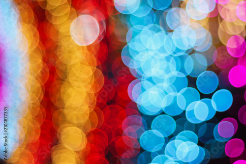 Beautiful colorful bokeh lights background texture with blur effect. Lots of round circles shiny red blue and gold colors for wallpaper decoration