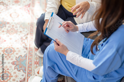 Schilderij op canvas Caring nurse and senior patient during comfortable home healthcare visit having