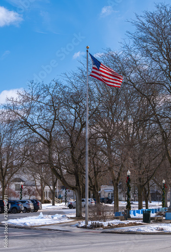 American flag in small town park in winter