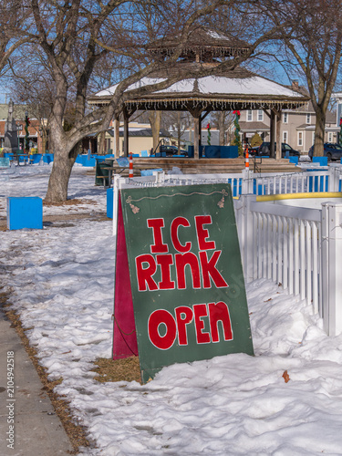 Ice rink open sign in snowy town park