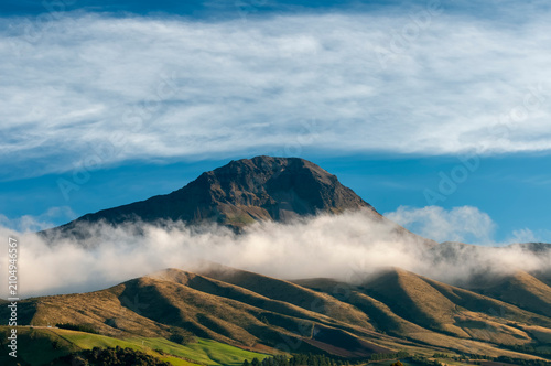 Majestic El Corazón Volcano at Sunrise Among Clouds in the Andes