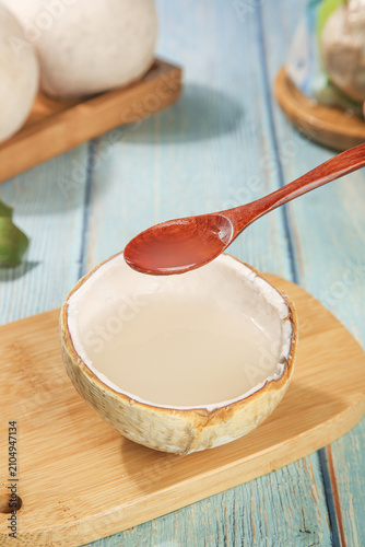 Fresh Coconut Juice Poured into Natural Shell Bowl - Tropical Drink Preparation