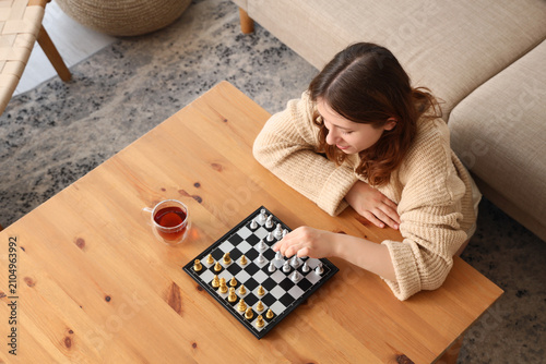 Young girl playing chess at...