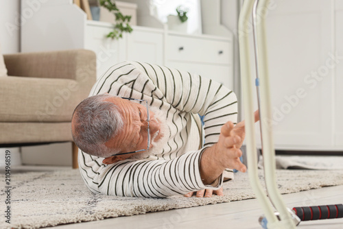 Senior man lying on carpet ...
