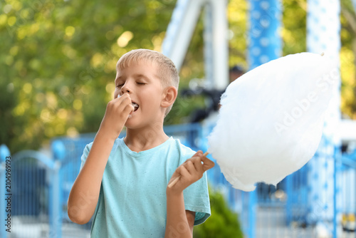 Teen boy eating cotton cand...