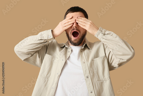 Shocked young man covering ...