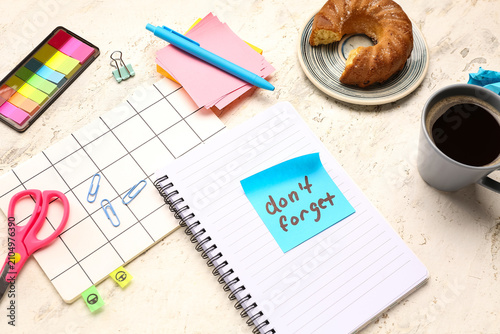 Canvas Print Sticky note with text DONT FORGET, stationery, coffee cup and croissant on grung