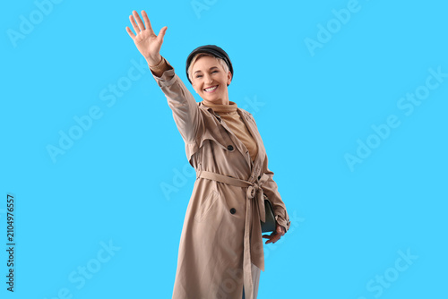 Stylish mature woman waving...