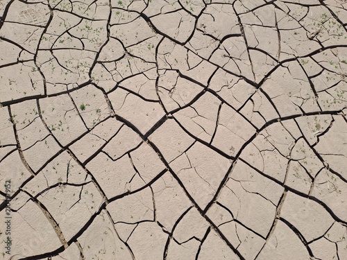 Cuadro en lienzo Dry cracked soil texture background caused by severe drought.