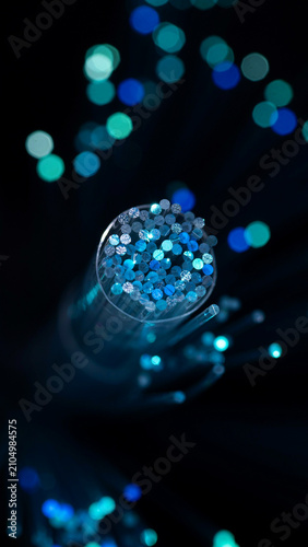 Macro view of blue fiber optic cable tip with bokeh lighting technology communication abstract connection internet transmission electronic telecommunication innovation