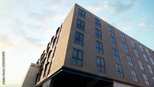 Modern building facade against blue sky in urban apartment complex