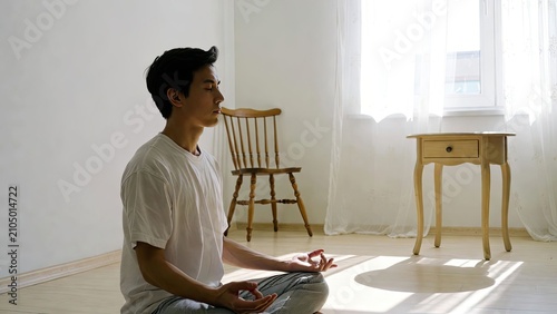 Mindful meditation practice young man in a serene indoor space embracing calmness and inner peace
