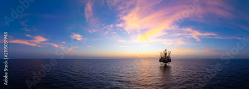 Aerial panoramic view of offshore jack up rig and offshore platform for oil and gas exploration and production.