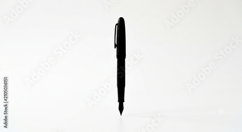 Фотография minimalist matte black fountain pen standing vertically on white background
