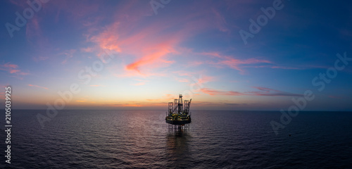 Aerial panoramic view of offshore jack up rig and offshore platform for oil and gas exploration and production.