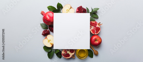Фотография Flat lay composition with Blank flyer poster and symbols jewish Rosh Hashanah holiday attributes on colored background, New Year holiday Traditional