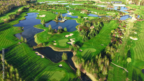 Quadro em tela Aerial golf course view with curved fairways and ponds