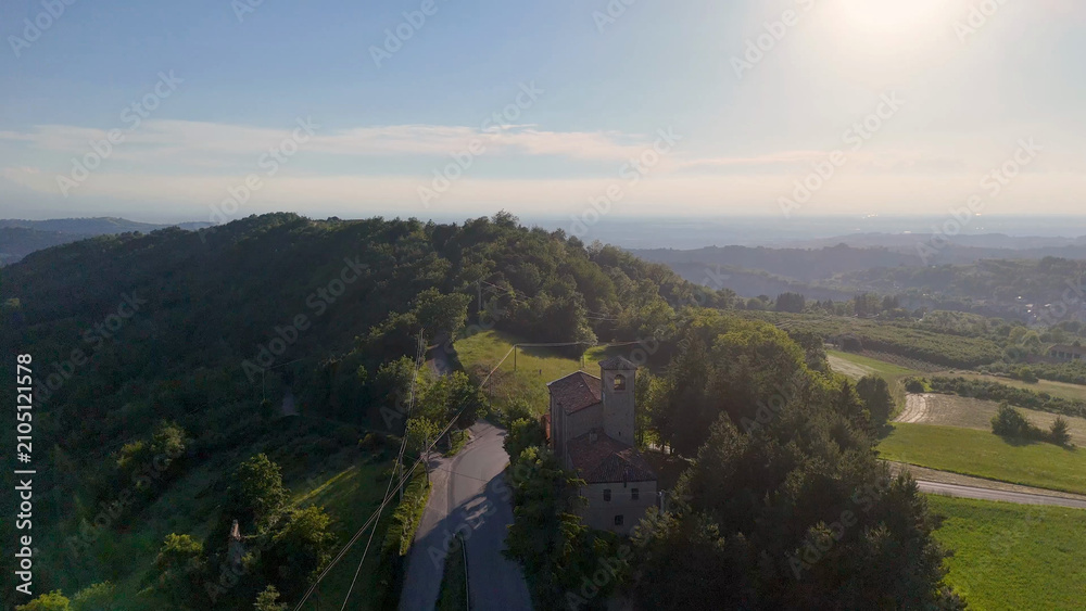 Obraz premium Aerial View of Historic Italian Church on a Wooded Hillside