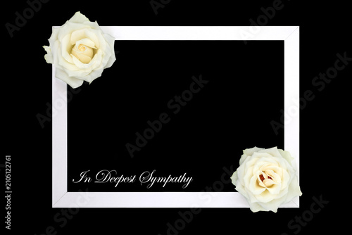 Fotografía In deepest sympathy rose flower tribute background border card on black with white frame and bow