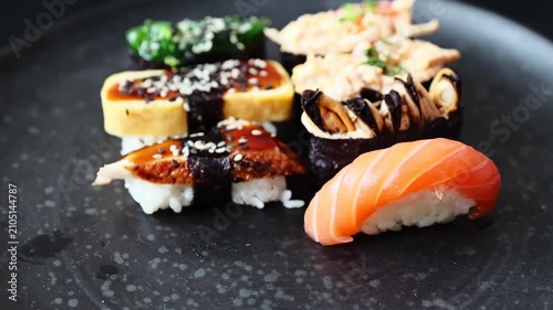 sushi on a black plate