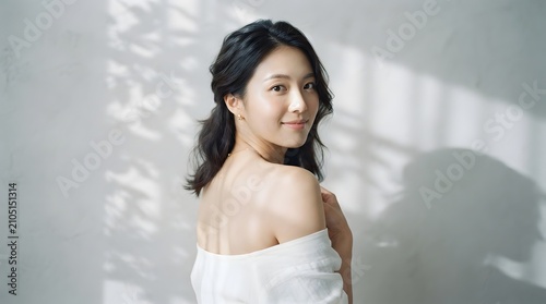 Smiling woman in soft natural light with shadow patterns