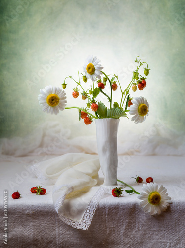 Still life with a bouquet of strawberries and daisies in a white vase on a light background
