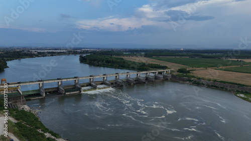 Принти на полотні Isola Serafini Dam on Po River in Italy showing water flowing through gates duri