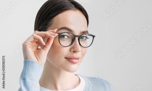Young beautiful woman isolated portrait. Student girl wearing glasses closeup studio shot, Young businesswoman smiling indoor, People, beauty, student lifestyle, business concept