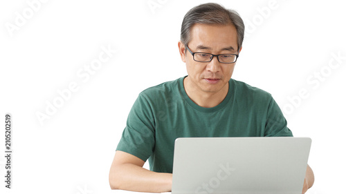 Senior Asian man using laptop on transparent background. Isolated. Concentrated mature man working on computer.