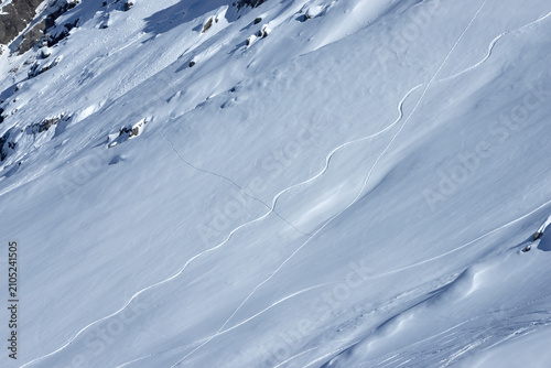 Konstfotografi Winter background of fresh ski tracks on a pristine snow slope in the Dolomites,