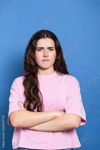 фотографія Young woman expressing anger and irritation with crossed arms