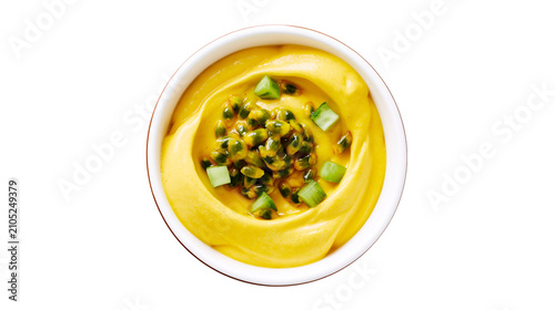 фотографія Yellow creamy sauce with passion fruit seeds and green herbs
