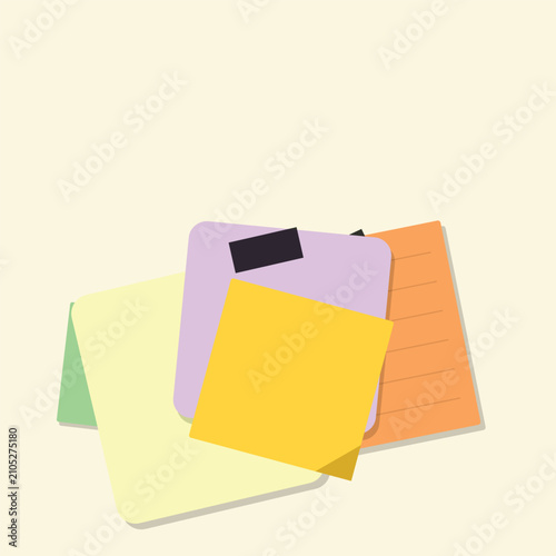 Colorful sticky notes and paper pads stacked together for office and school organization